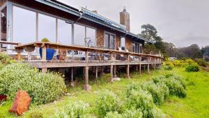 a building with a deck on the side of it at Windrose in Fort Bragg