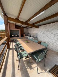 a large wooden table and chairs on a patio at Villa hibiscus in Sainte-Suzanne