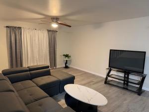 a living room with a couch and a flat screen tv at Beautiful Colonial in the Poconos in Tobyhanna