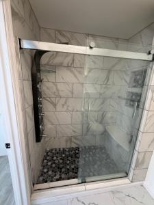 a shower with a glass door in a bathroom at Beautiful Colonial in the Poconos in Tobyhanna +20 photos