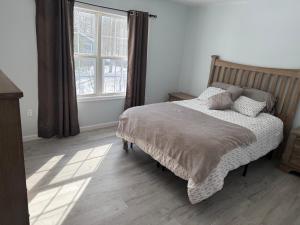 a bedroom with a bed and a large window at Beautiful Colonial in the Poconos in Tobyhanna