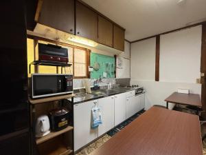 a small kitchen with a sink and a microwave at Hareumi in Tamano +21 photos