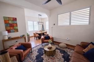 a living room with couches and a table at Villa Zoed in San Juan