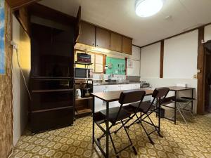 a kitchen with a table and chairs in it at Hareumi in Tamano