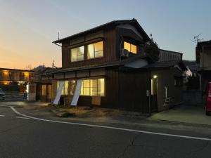 a house that is sitting on the side of a street at Hareumi in Tamano
