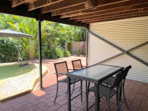 a patio with a table and chairs next to a swimming pool at Horseshoe Haven in Horseshoe Bay