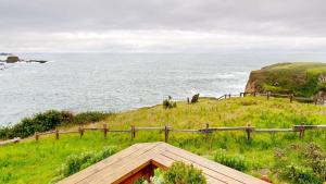 a view of the ocean from a wooden bench at Windrose in Fort Bragg