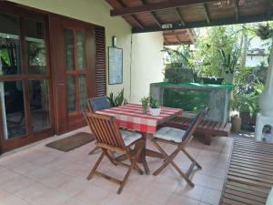 a table and chairs on a patio with a fireplace at Mallis Guesthouse in Habaraduwa Central