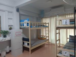a room with two bunk beds in a room at Middle Road Hostel in Nathon Bay