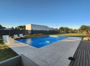 a swimming pool with two lounge chairs in a yard at Quinta Soñada Junin in Junín