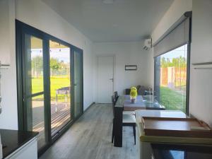 a kitchen with a dining table and a large sliding glass door at Quinta Soñada Junin in Junín