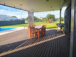 a patio with two chairs and a table on a house at Quinta Soñada Junin in Junín