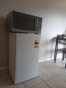 a microwave sitting on top of a refrigerator at Wattleview in Lithgow