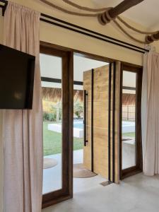 a room with a sliding glass door with a tv at Lasa, private villa with private pool in El Nido