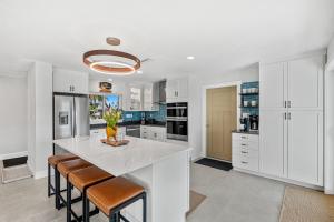 a kitchen with white cabinets and a large white island at 126 Deleon Rd in Cocoa Beach