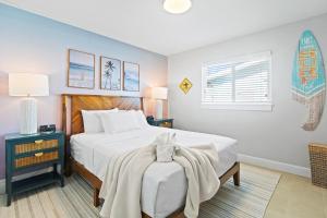a bedroom with a bed with a blanket on it at 126 Deleon Rd in Cocoa Beach +45 photos