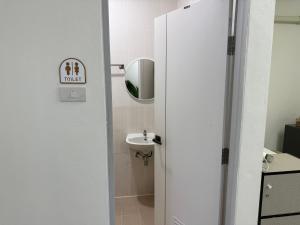 a bathroom with a sink and a toilet and a mirror at Summer Sand in Haad Rin