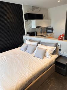 a bed with four pillows on it in a room at Utopia Dream in Rawai Beach +11 photos