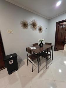 a dining room with a wooden table and chairs at Secret Hideaway in Ocho Rios +7 photos