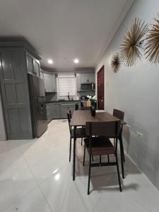 a kitchen with a table and chairs in a room at Secret Hideaway in Ocho Rios