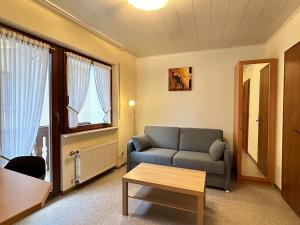 a living room with a couch and a table at Gästehaus im Oberdorf in Erden