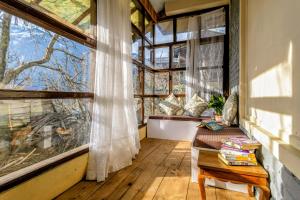 a room with a table and a large window at Zeyul Homes in Manāli
