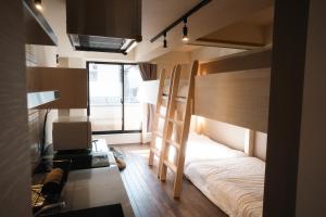a room with a bunk bed and a desk with a desk at Condominium MIRAHAKONE in Hakone