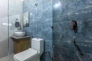 a bathroom with a toilet and a sink at By the Lake Boho Bhimtal in Bhīm Tāl