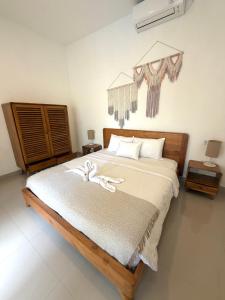 a bedroom with a large bed with white sheets at Villa Nala - Uluwatu Nusa Dua in Ungasan +12 photos