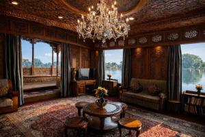 a living room with a chandelier and a couch and a table at Mascot Houseboats in Srinagar