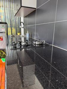 a kitchen with a black counter top and a stove at Twenty ritz cottage in Migori