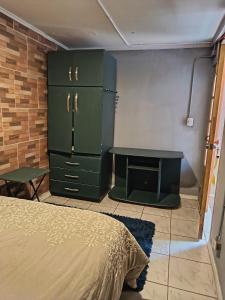 a bedroom with a bed and a desk and a table at Casa Hostel Javi in Santiago