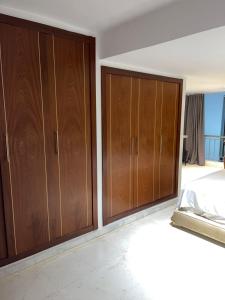 a bedroom with wooden cabinets and a bed at Saada in Tangier