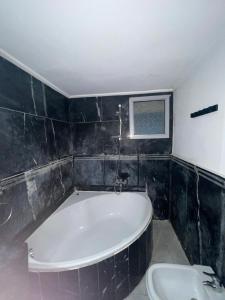 a bathroom with a bath tub and a sink at Saada in Tangier +17 photos