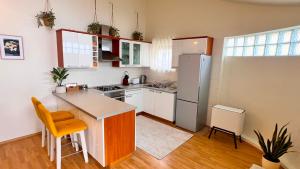 a kitchen with a refrigerator and a counter top at Luxury Beach Villa, Sibenik in Šibenik