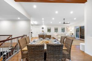 a dining room with a table and chairs at Surfmist by the Beach Pet Friendly with Pool in Kingscliff