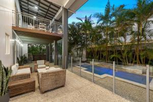 an indoor patio with a view of a pool and a house at Surfmist by the Beach Pet Friendly with Pool in Kingscliff