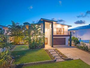 a house with a balcony and a yard at Surfmist by the Beach Pet Friendly with Pool in Kingscliff