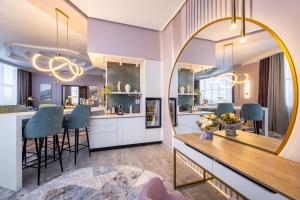 a kitchen and dining room with a large mirror at Monotel Hotel in Ustʼ-Kamenogorsk