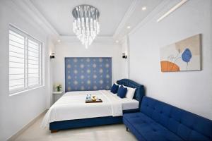 a bedroom with a blue bed and a blue couch at Miah Ha Noi Hotel - the best choice in Hà Nội Old Quarter in Hanoi +14 photos