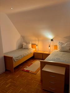 a room with two beds and two night stands at Beehome Wietzendorf in Wietzendorf