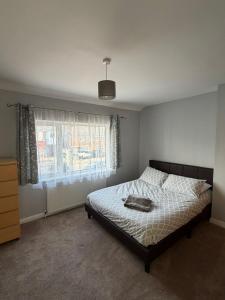 a bedroom with a bed and a window at Jerry's lane 3 bed house free parking free wifi in Birmingham