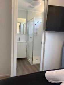 a bathroom with a shower and a mirror at Denman Van Village in Denman +77 photos
