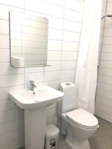 a white bathroom with a sink and a toilet at Vestby Park in Vestby +17 photos