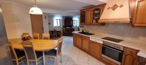a kitchen with a wooden table and a dining room at Wunderschöne Ferienwohnung in Thüringen in Langenorla +23 photos