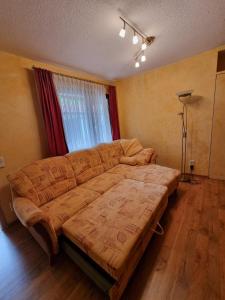 a large bed in a room with a window at Wunderschöne Ferienwohnung in Thüringen in Langenorla