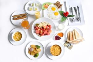 a white table with plates of breakfast food on it at Trishuli Villa in Benighāt