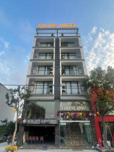 a tall building with a sign on top of it at Coline Hotel & Aparment in Ninh Binh