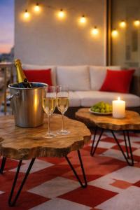 two wine glasses on a table with a bottle of champagne at Luxury Maubourg - Vue mer - Croisette 50m plage - Clim - terrasse in Cannes