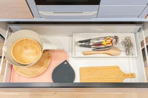 a drawer full of kitchen utensils and a cup of coffee at The Bear ベアSpacious Holiday Villa in Inzai